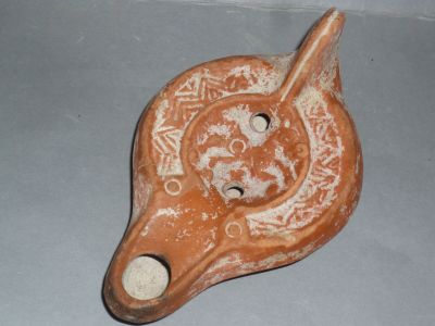 a clay animal head with a hole in the middle of it