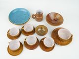 many cups and saucers sitting on a white table