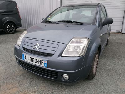 a small grey car parked in front of a building