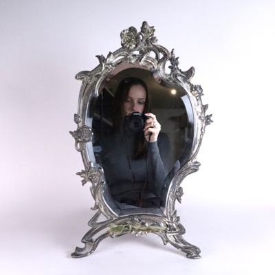 a woman taking a picture of herself in a mirror