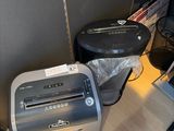 a paper shredder sitting on the floor next to a trash can