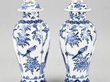 pair of blue and white vases with birds and flowers on them