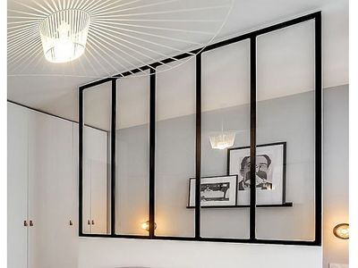 a bedroom with a bed and pictures on the wall