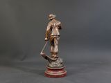 a bronze statue of a man with a dog on a pedestal