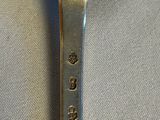a close up of a spoon on a table with a white cloth