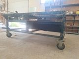 an image of a metal table with wheels in a garage
