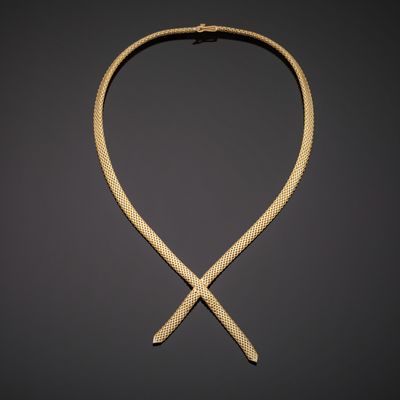 a gold necklace on a black background