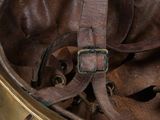 a helmet that has a leather strap on it