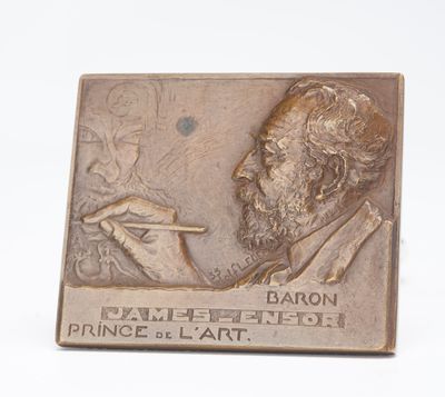 bronze plaque of a man with a pipe in his hand