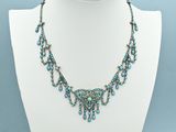 a necklace with blue beads on a white mannequin