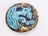 an image of a blue and gold button with a dragon on it