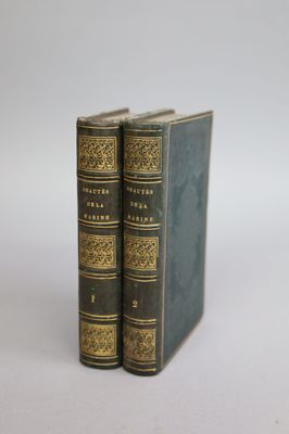 two books sitting on top of each other on a white surface