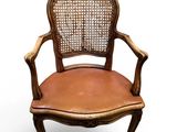 an image of a wooden chair with a brown leather seat