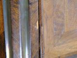 a close up of a wooden door with a metal handle