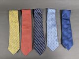 four different colored ties are lined up on a table