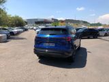 a blue car that is parked in a parking lot
