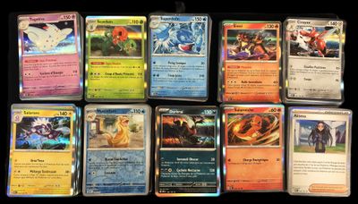 a lot of different pokemon cards on the table