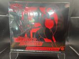 anime figure display case with a red and black poster on it