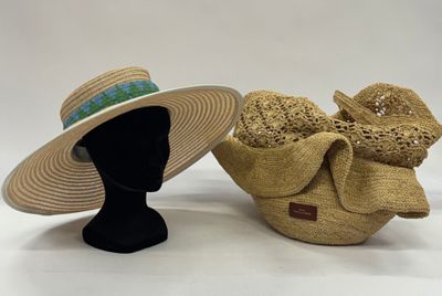 pair of straw hats with bows on display on white background