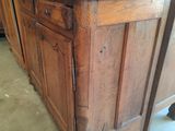 a wooden cabinet with a drawer on top of it