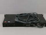 a close up of a black device on a white surface