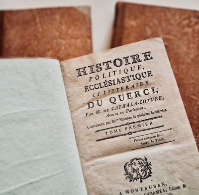 a book that is open on a table with other books