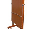 the large wooden table is on wheels and has a coat rack