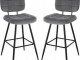 pair of grey velvet bar stools with black metal legs