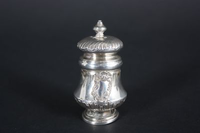 an antique silver salt shaker on a black background