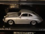a model of a silver car in a display case