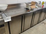 a large stainless steel counter with a bowl on top of it