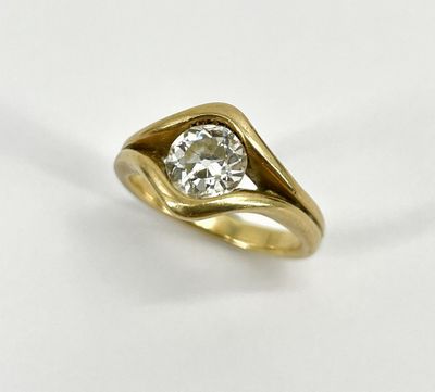 a close up of a diamond ring on a white surface