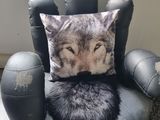 a black chair with a pillow on top of it