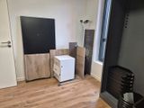 a small white refrigerator in the corner of a room