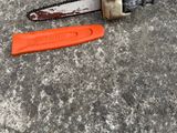 a chainsaw that is laying on the ground next to a tool