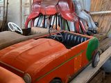 a red toy car with a horse on top of it