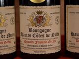 three bottles of wine sitting on top of a table next to each other