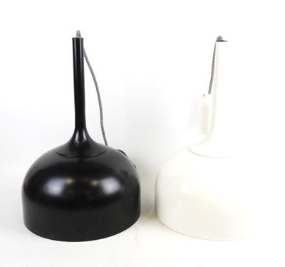 two black and white vases sitting next to each other