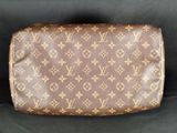 a brown louis vuittou toilet bag on a black background