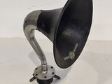 an old fashioned black and silver gramphone on a white surface