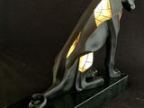 an image of a statue of an egyptian cat on a black background