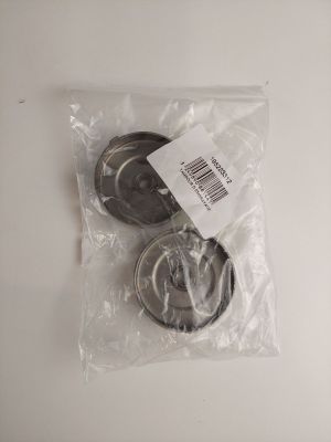 two pieces of metal are in a plastic bag on a white surface
