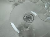 many wine glasses sitting on a table next to each other