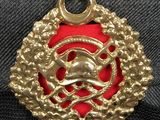 a close up of a gold medal with a red ribbon