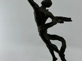 bronze statue of a man holding a spear on a rock