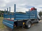 a blue truck that is parked on the side of the road
