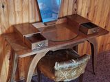 a desk with a chair and a mirror in the corner of the room