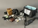 the contents of a camera bag are laid out on the table