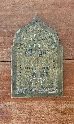 a brass plaque on a wooden wall that reads the name of a man