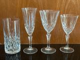 four wine glasses sitting on a table next to each other